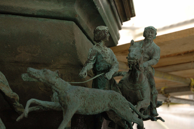Detail of hunting scene on base of statue