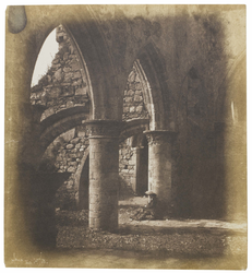 Woman seated under an arch at Iona Abbey