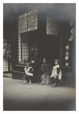 Family sitting next to butcher's shop, Canongate