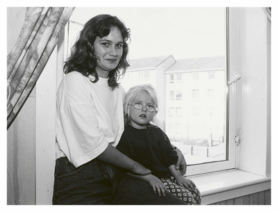 Woman and child sitting in window, Wester Hailes
