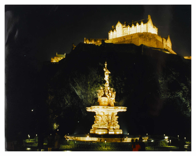 Edinburgh Castle and Ross Fountain illuminated at night