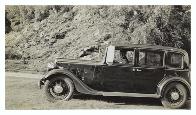 Walter Lyle, Chauffeur, in a car beside a rocky hill