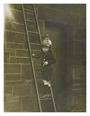 Young boy in fireman's outfit