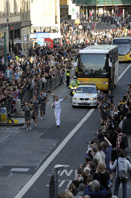 Olympic Torch runner and security officers 
