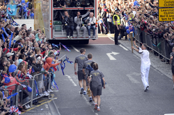 Olympic Torch Runner and security officers