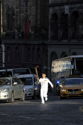 Young Olympic Torch runner, running up Victoria Street