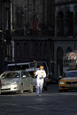Young Olympic Torch runner, running up Victoria Street