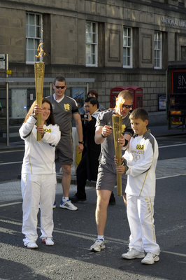 Olympic Torch relay runners with security officers
