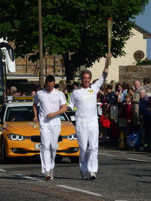 Olympic Torch Relay runners passing through Musselburgh
