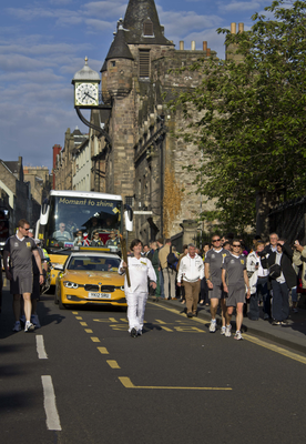 Olympic Torch Relay Runner walking down the Canongate