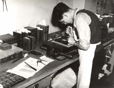 A bookbinder at work in his printer's workshop