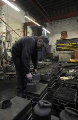 Weights being placed on the casting moulds