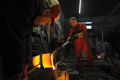Pouring molten iron into the moulds