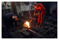Pouring molten iron into moulds