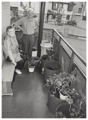 Couple standing in their balcony garden, Wester Hailes