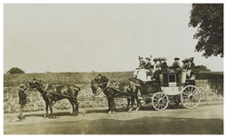 A waiting stagecoach pulled by three horses