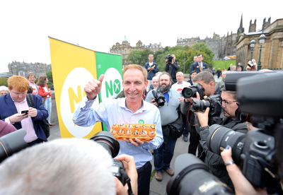 Jim Murphy poses to the press with a box of eggs 