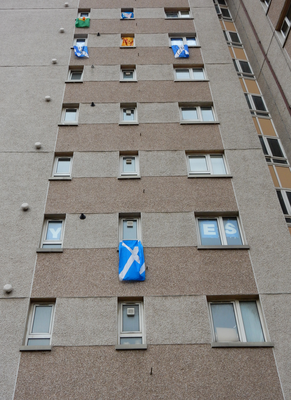 Tower block flats with Yes campaign poster and flags