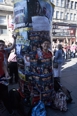 Street performer wrapped up in promotional posters