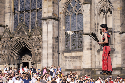 Street performers on stilts, juggling