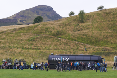 Team Sky bus in Holyrood Park, Arthur's Seat behind