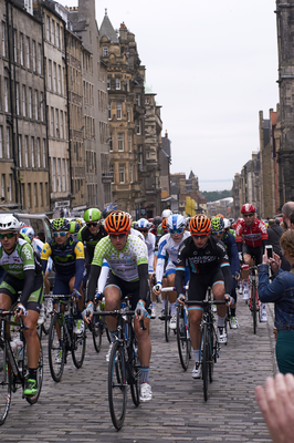 Riders cycling up the High Street 