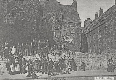 Large group of children in front of old houses, Leith