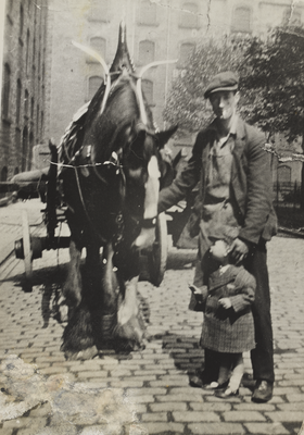 Lorry Driver standing with horse and cart 
