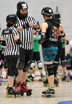 Roller derby referees in discussion