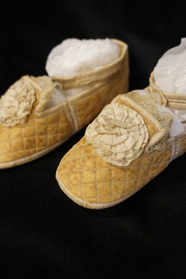 Infants' gold quilted silk shoes, c1880-1900
