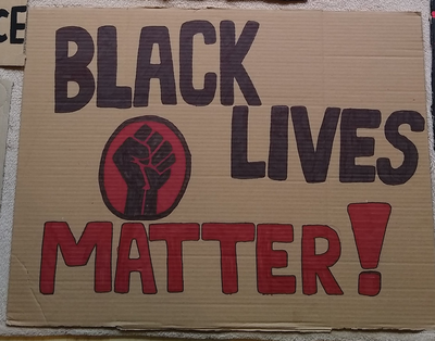 A placard simply stating 'Black Lives Matter'
