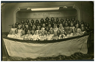Four rows of children dressed as fishermen and women