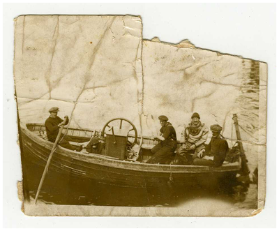 Photograph, four men in a boat, one in a diving suit